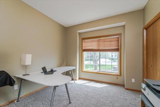 The main floor den/office has gridded glass French doors and a closet. Large windows overlook the front of the home. This room has BRAND NEW carpet!