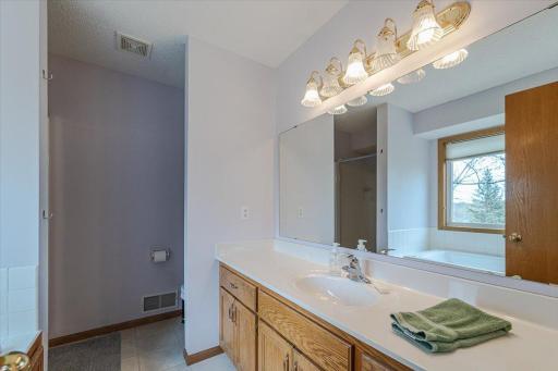 A full, private bath with a jetted tub, separate shower and dual sink vanity is attached.