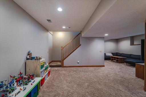 The lookout lower level takes in views of the backyard! You’ll enjoy nights at home in this cozy, inviting space with a family room, game space, guest accommodations and storage space.