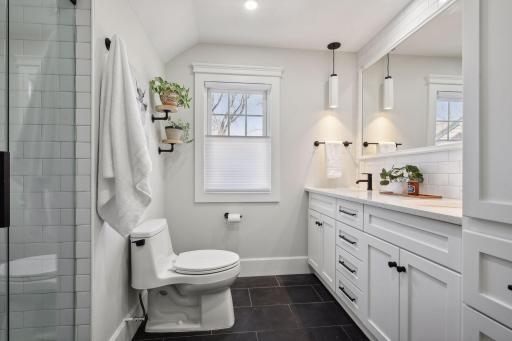 Beautifully renovated second floor bathroom with double sinks and walk-in shower.