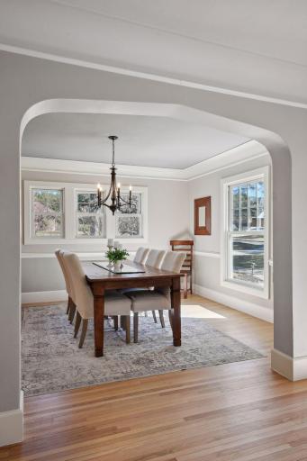 The dining room is beautiful with original archways and gorgeous new color poured over every surface.