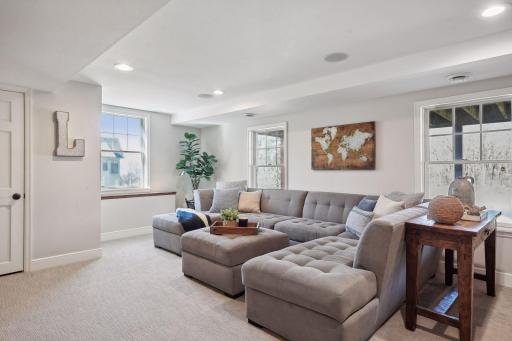 This lower level family room feels bright and airy with natural light pouring in.