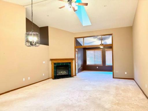 Huge great room, vaulted with fireplace, skylight and ceiling fan.
