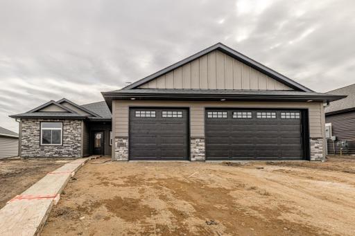 3 bedroom, 2 bath slab on grade executive home with an oversized 3-stall garage. Home has a grand feeling with 9' ceilings, gas fireplace with side built-in cabinets, LVT flooring throughout common areas, stained premium alder cabinetry and more!