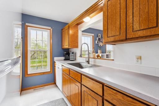 Kitchen features plenty of storage cabinets, a lookout window and pass through.