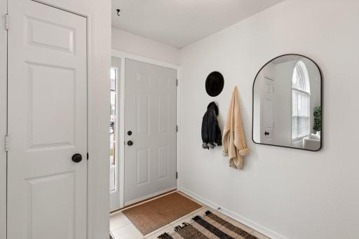 Bright, spacious entryway and coat closet.