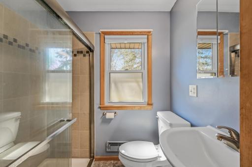 Main level bathroom features a walk-in shower with tile surround.