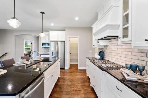 All our features are standard including the granite countertops, tile backsplash and under mount kitchen sinks. (pic from a previous model).jpg