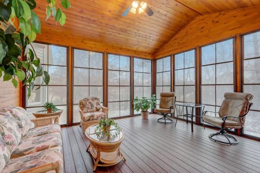 Off the four season porch is access to the 3-season porch with another 12-foot vaulted ceiling, tongue-and-groove surround, and floor-to-ceiling windows.