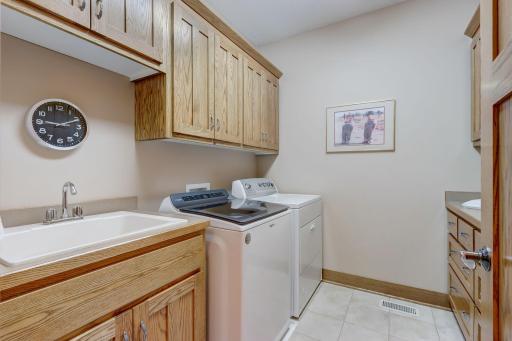 Convenience meets style with a main level laundry room with abundant storage.