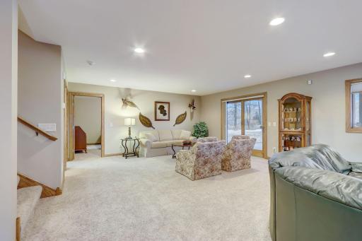 Expansive family room and recreation room with gas-burning fireplace, wet-bar, surround sound, and access to the backyard patio.