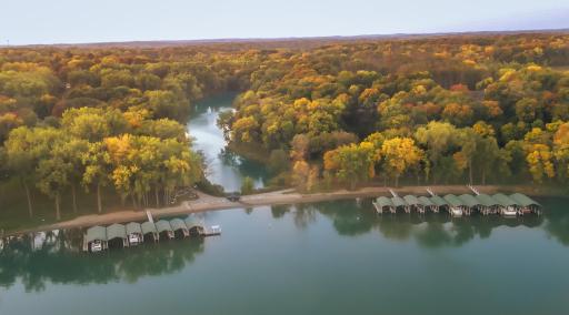 Absolutely stunning and distinctive Trillium residence, offering an unparalleled lifestyle with exclusive access to a private beach and enchanting pathways leading you directly to the pristine shores of Lake Minnetonka.