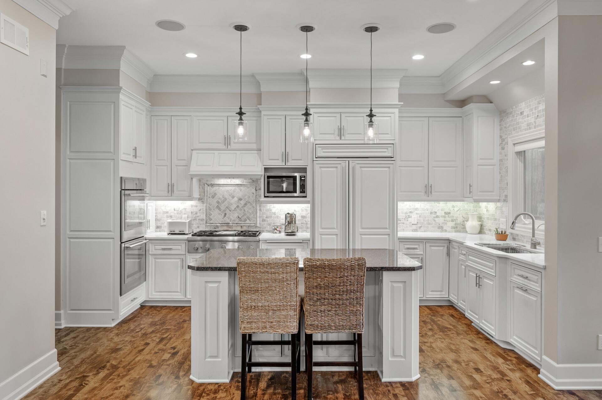 The gourmet kitchen is a chef's dream, boasting custom cabinetry, integrated appliances, and pristine finishes.