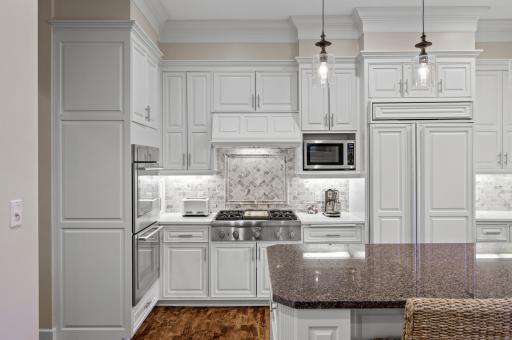 The large center island invites gatherings and conversations, while the double wall oven and gas cooktop with an exhaust fan ensure culinary excellence. The Culligan reverse osmosis drinking water system, new Culligan water softener & filter system.
