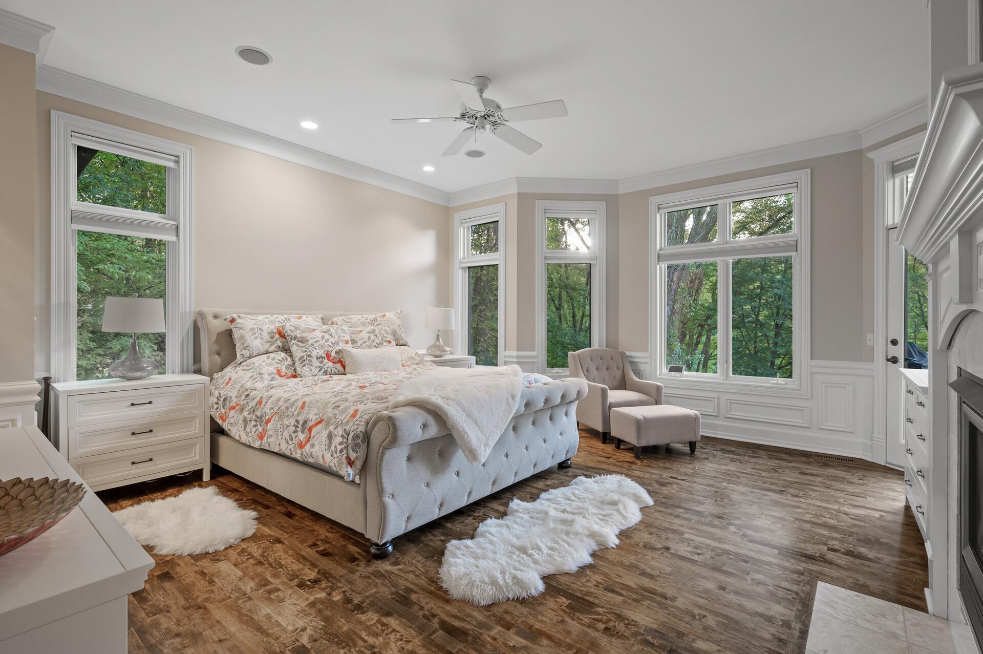 The primary oasis features a gas fireplace, serene lake views, and access to the deck.