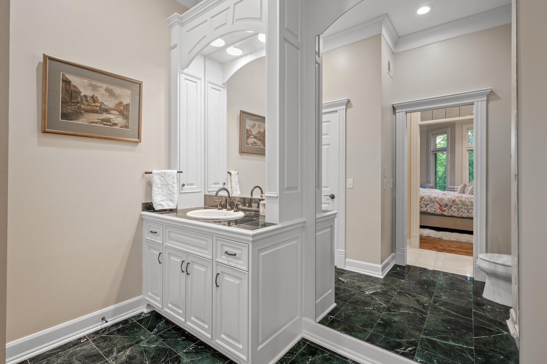 His and hers separate bathrooms with separate closets add convenience and luxury.