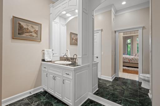 His and hers separate bathrooms with separate closets add convenience and luxury.