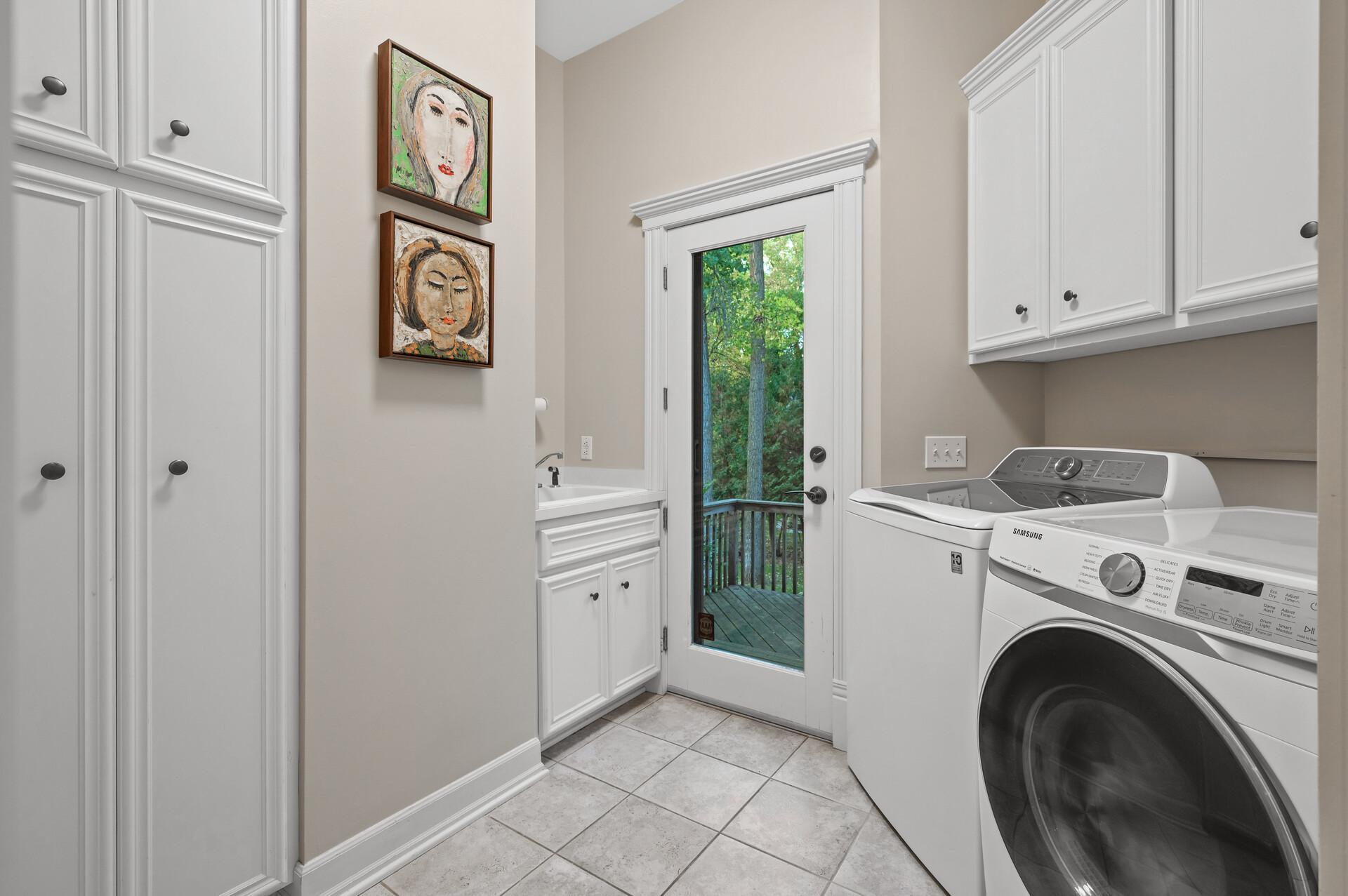 Convenient main level laundry room with access to the backyard.