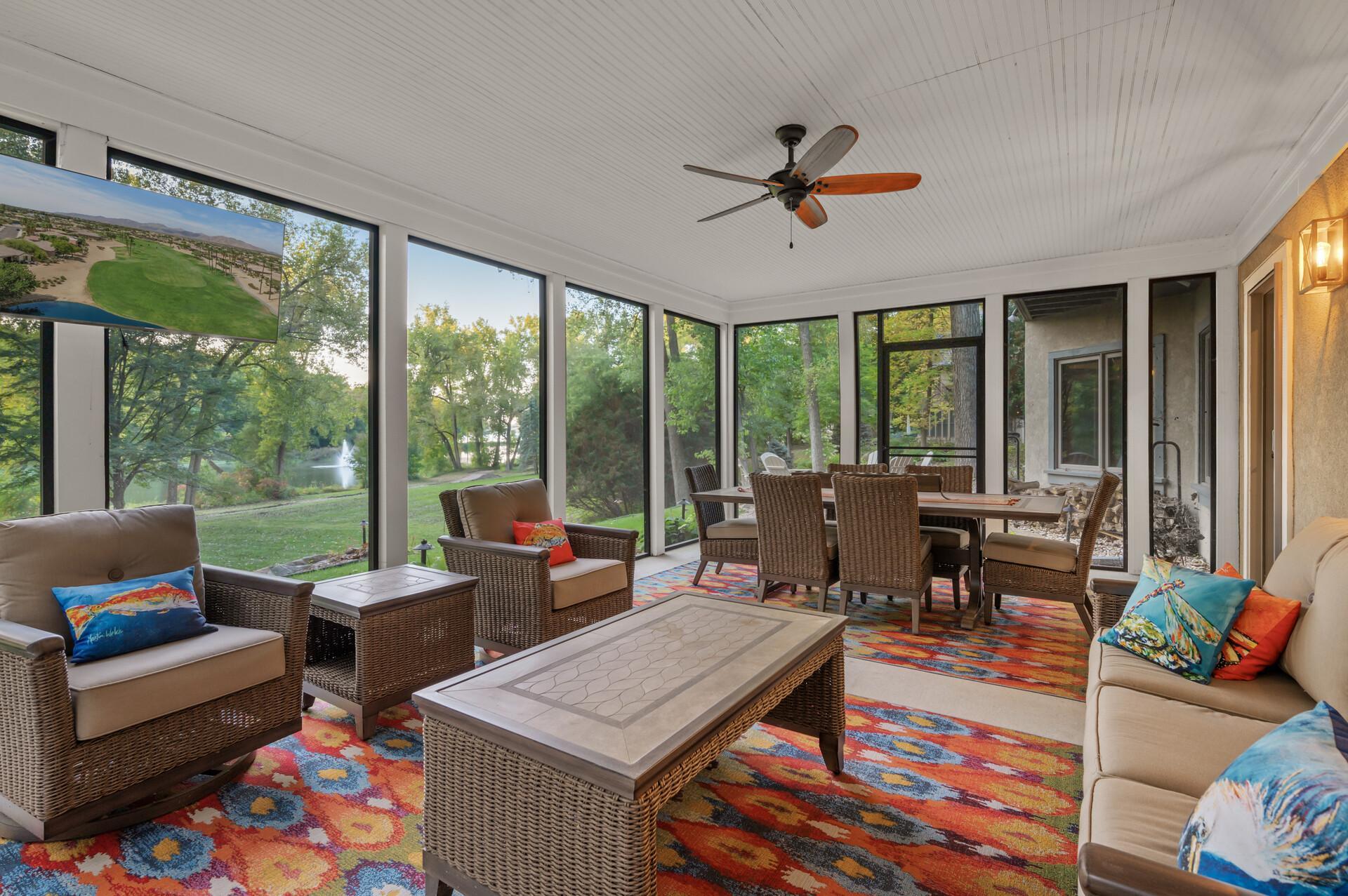 Step into the three-season screened porch, which leads to the backyard and hot tub, providing a perfect spot for outdoor enjoyment.