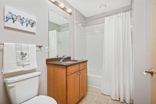 Full bathroom for guests features ceramic tile floors.
