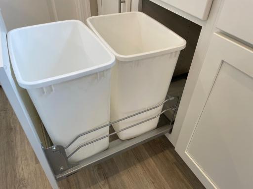Kitchen cabinet includes a trash/recycling pullout conveniently located next to the sink.
