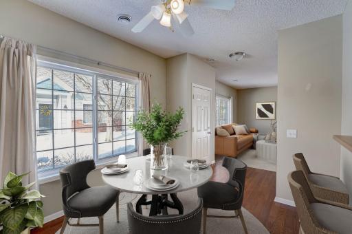 Formal dining space with oversized windows, extra eat-in breakfast bar. This room has been virtually staged.