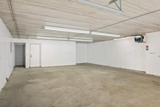 Heated 3rd car garage under house! You could even set up a pickleball court in here!