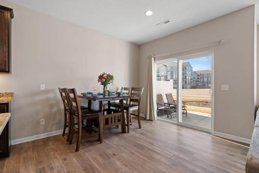 Enjoy dining next to the patio, accessible through sliding glass door. Natural light fills the room while you are dining.