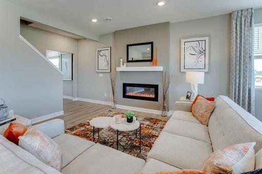 One of many highlights in the main level, the homes fireplace offers a touch of modernization of a space already loaded with a contemporary layout! (Photo of model, colors are similar)
