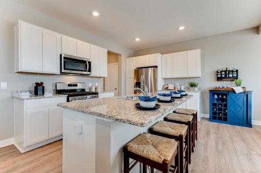 A kitchen built to perform - complete with stainless appliances and a vented microhood, stunning cabinetry and loads of space to maneuver about!! (Photos of the same floorplan, colors are similar).