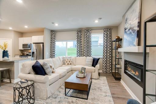 Soaring windows shed light on a main level living space that is large enough to handle most furniture set-ups and features a contemporary electric fireplace and mantle combination! See sales agent for details on color selections.