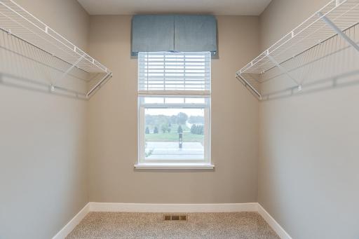 Plenty of space in this primary closet for anything you may need. Photos shown of same floorplan, see sales agent for details on color selections.