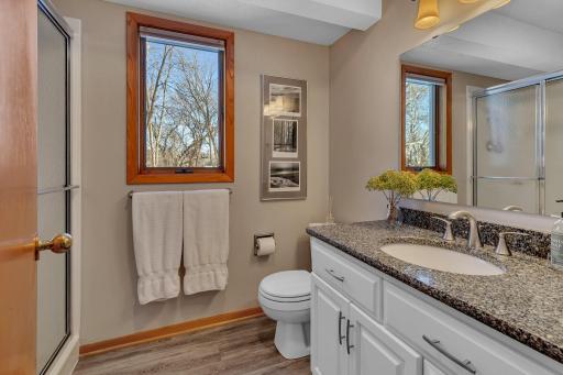 Cabinet style and design carries through the 3/4 bath just beyond the main floor laundry~glass shower door adds to the simple elegance!