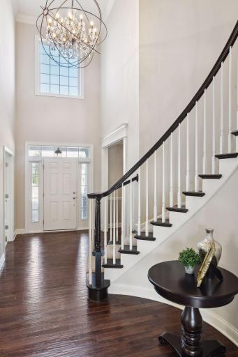 Impressive 2-story foyer embellished beauitful wood flooring.