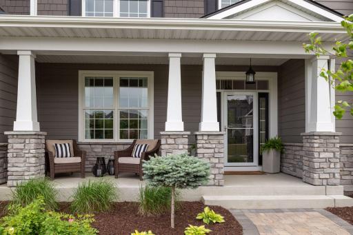 Fabulous curb appeal with many exterior upgrades, included paver sidewalk, tapered columns wrapped in stone and professional landscaping.