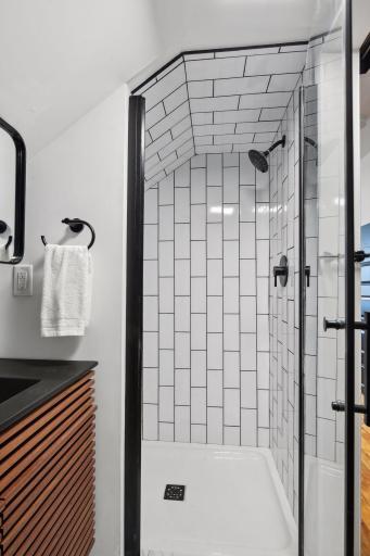 Loving the vertical subway tile on the shower ceiling too! The glass shower door keeps it bright and light