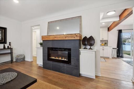 Wonderful wood accents can be found throughout - new fireplace mantel check out that massive beam to the right making the new open dining room possible