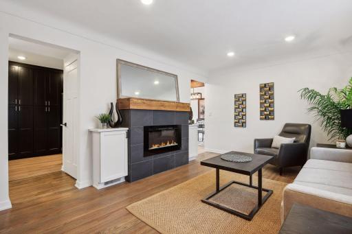 Fireplace feature wall showcasing some of the several natural wood and black color accents throughout