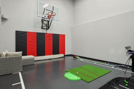 The two-story sport court is a standout feature! Set up for basketball, perfect for practicing golf, tennis, or hockey.