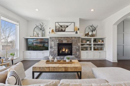 Stone gas fireplace with flanking bookcases with lots of storage.