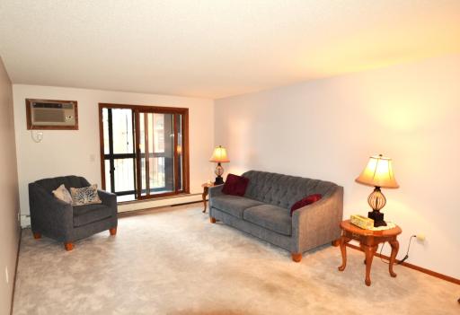 Living room with newer plush carpeting, newer A/C, and window were replaced in both patio doors.