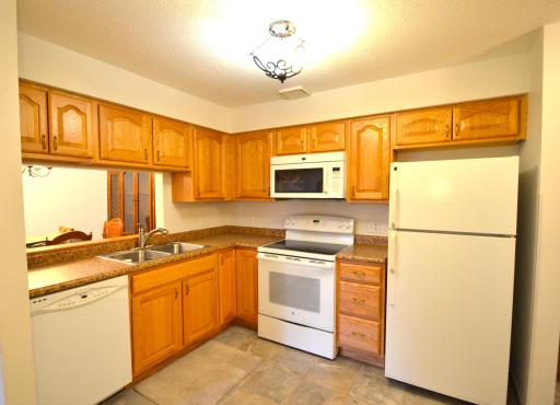 Updated kitchen. Newer cabinets, countertop, sink, appliances, and ceramic flooring.
