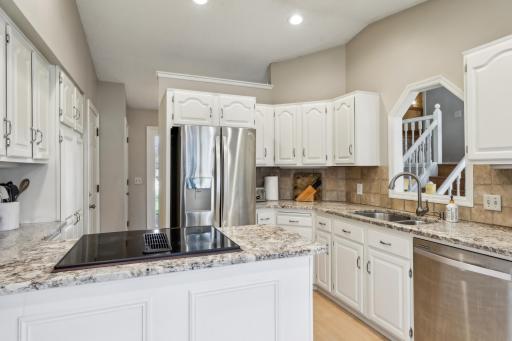Updated kitchen features granite counters and stainless appliances