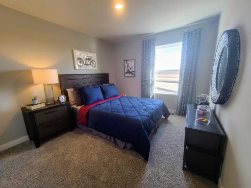 Each of the home's spacious secondary bedrooms feature well thought out window locations. Photo is of model home. Colors and options may vary. Ask Sales Agent for details.