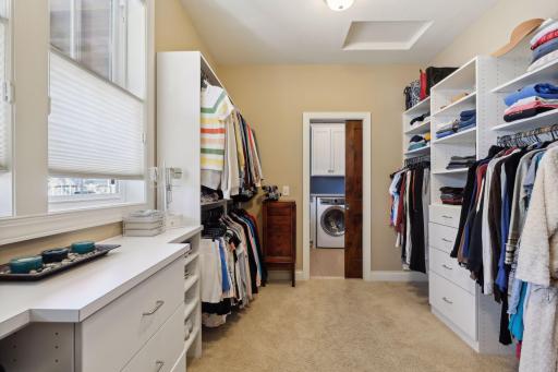 Spacious primary walk-thru closet with access to laundry room