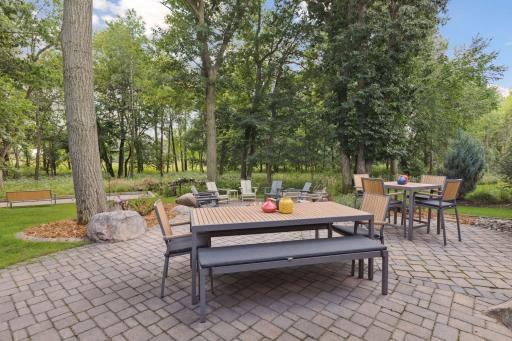 Meticulously landscaped backyard with alluring paver patios - note the multiple dining areas