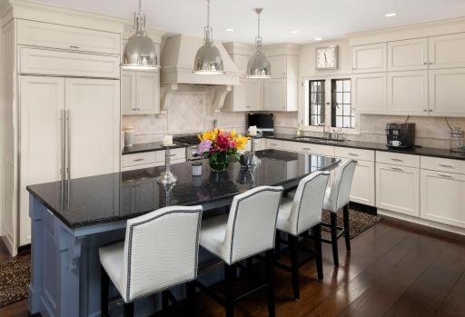 The kitchen features modern lighting, Thermador appliances and granite countertops.