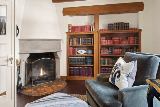 The fireplace enhances the library by providing warmth and an aura of timeless sophistication. Whether curled up with a classic novel or entertaining guests, the library is sure to inspire moments of serenity and intellectual stimulation.