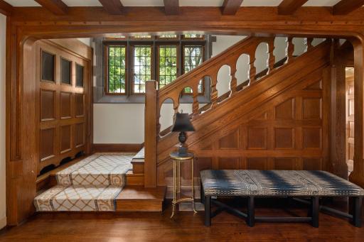 Ascend the grand staircase adorned with exquisite woodwork, a captivating focal point that showcases the home's craftsmanship.