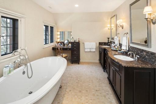 Indulge in the ultimate relaxation in the owner's bath, featuring an expansive double sink vanity, a separate makeup vanity and an Ultra Air soaking tub for a spa-like experience.
